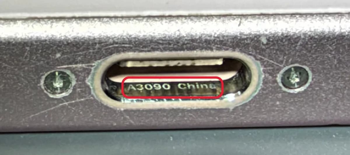 iPhone USB-C charging port with the number A3090 highlighted inside